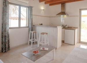 uma cozinha com um balcão e uma mesa num quarto em Viviendas Ferrer - Formentera Break em Es Migjorn