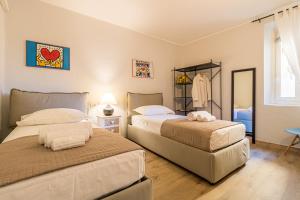 a bedroom with two beds and a window at Apartment delle Rose - Menaggio in Menaggio