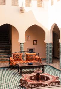 a living room with a couch and a table at Dar Marhaba Merzouga in Merzouga