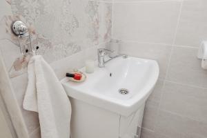 a white bathroom with a sink and a toilet at Apartman Branko in Zaboric +26 photos