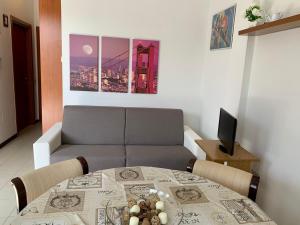 a living room with a table and a couch at Sweet Harmony in Lucca