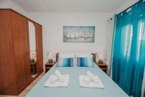 a bedroom with a blue bed with two pillows at Apartman Branko in Zaboric