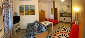 - un petit salon avec un canapé et un lit dans l'établissement Appartamento affitti brevi Verona Colors/G.B. Rossi friendly, à Vérone