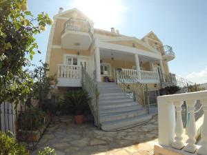 a house with white stairs and a fence at Irini's Villa in Argostoli