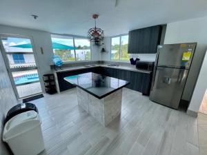 a kitchen with a refrigerator and a table in it at ESPECTACULAR Casa Quinta en Melgar in Melgar