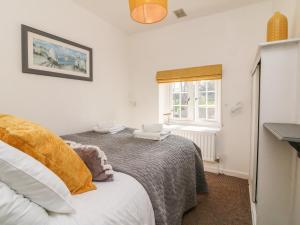 um quarto com uma cama e uma janela em Robin Cottage em Ilfracombe