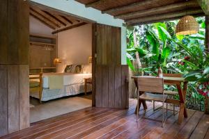 een slaapkamer met een bed, een tafel en een bureau bij Casa Das Águas Trancoso in Trancoso