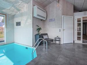 a swimming pool in a room with at 9 person holiday home in Juelsminde in Sønderby