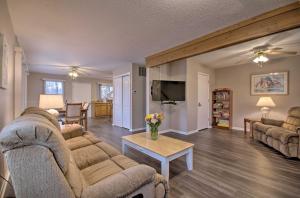 a living room with two couches and a table at On-the-Water Retreat with Dock Pet Friendly! in Lake Ozark