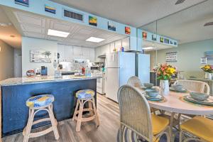 a kitchen with a table and chairs and a refrigerator at Oceanfront Oasis with Deck and Resort Beach Access! in Myrtle Beach