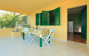 a dining room with a table and chairs on a patio at Beautiful Home In Blato With 3 Bedrooms And Wifi in Blato