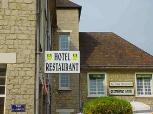 a sign for a hotel restaurant in front of a house at Le Clos Normand in Troarn