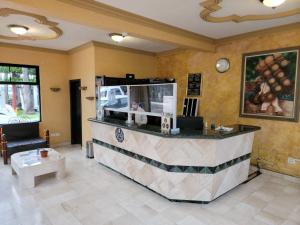 a restaurant with a counter in a room at Hotel Paraiso Las Palmas in Ensenada