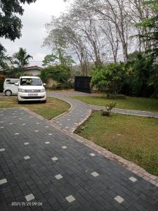a white car parked on a winding road at Discovery resort in Ratnapura