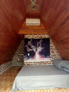 a bed in a room with a fireplace at Homestay Bình Huy in Mộc Châu