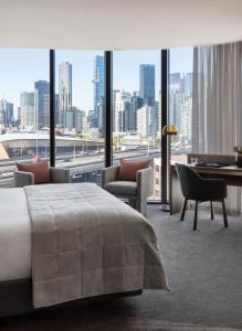 a hotel room with two beds and a large window at Oakwood Premier Melbourne in Melbourne