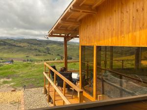 a wooden house with a view of the hills at GranMount Cabañas in Boyacá