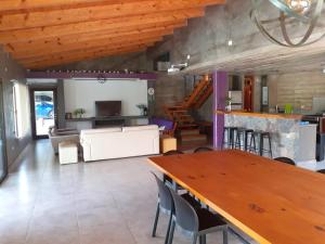 a living room with a table and a couch at Hermosa casa con pileta asador patio de fuego in San Salvador de Jujuy