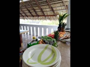 a table with a white plate and some fruits and vegetables at Private room with king size bed in Puerto Escondido +28 photos