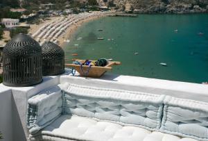 Blick auf den Strand mit einem Boot im Wasser in der Unterkunft Melenos Art Boutique Hotel in Lindos