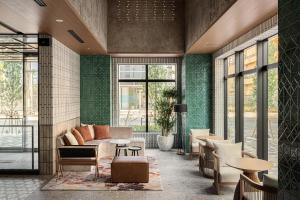 a living room with a couch and a table at Nest Hotel Naha Nishi in Naha