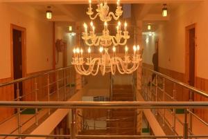 a large chandelier in a building with a staircase at Hotel Pride in Kalimpong