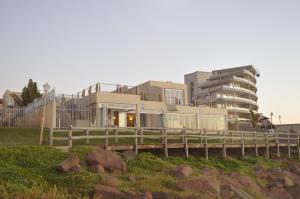 a building with a bridge in front of a building at Sunshowers Ballito in Ballito