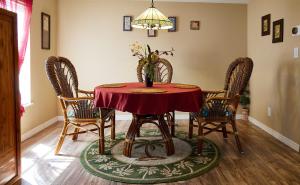 a dining room table with a red table cloth and chairs at Pleasant Days Lodging Tropical Master Suite in Homosassa