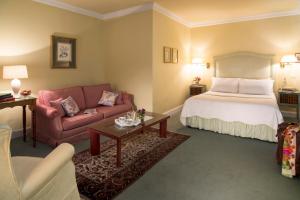 a hotel room with a bed and a couch at Aherne's Townhouse Hotel and Seafood Restaurant in Youghal