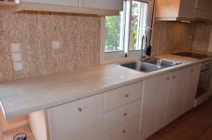 a kitchen with a sink and a counter top at Villa Aliki in Petrokhorion