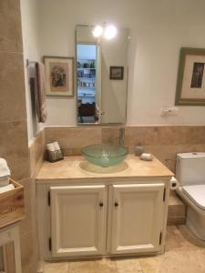 a bathroom with a sink and a mirror at Coeur de l'Arquet in LʼIsle-sur-la-Sorgue +6 photos
