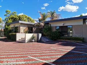 a house with a brick driveway in front of it at The OutLook Guest House in Newcastle