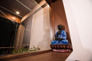 a statue of a man sitting in a room at MUSHROOMS in Vasco Da Gama