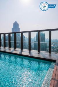 a swimming pool on the roof of a building with a view at Urbana Langsuan Hotel in Bangkok