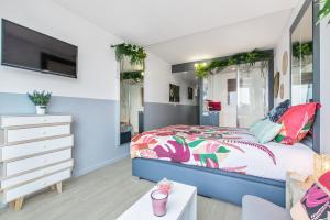 a bedroom with a bed and a dresser and a tv at Sweet dream Port nature in Cap d'Agde