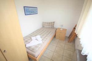 Dormitorio pequeño con cama y vestidor en Deichstraße 15 W 14, en Norddeich