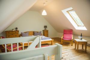 a attic room with a bed and a window at Haus Seenland in Feldberg