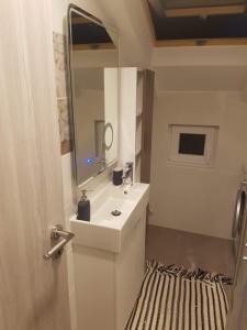 a bathroom with a sink and a mirror at Apartments and Rooms Ivana in Krk