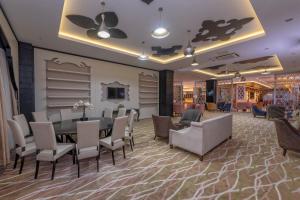 a dining room with a table and chairs at Lake River Side Hotel Spa in Side