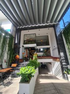 a building with a patio with tables and chairs at Lyly's House - Homestay in Ho Chi Minh City