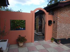 a gate to a house with a brick wall at self-contained private apartment in Barnet