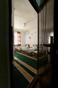 Postel nebo postele na pokoji v ubytování Sulaymon Guest House