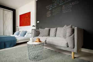 a living room with a couch and a bed at Irundo Downtown Apartments in Zagreb