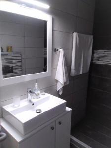 a bathroom with a white sink and a mirror at Studio Marina in Sivas beautiful Village in Sívas