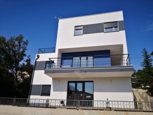 a white building with a balcony on it at Apartment in an urban villa Kraljevica in Kraljevica
