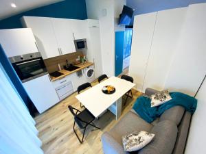 a living room with a couch and a table at BalnéoPlage in Jard-sur-Mer