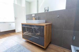 a bathroom with a sink and a sink at FullHouse - Zwickau - F45 Apartments - SmartTV - Nespresso in Zwickau