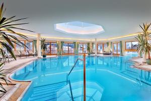 a large swimming pool in a building at Hotel Singer – Relais & Châteaux in Berwang