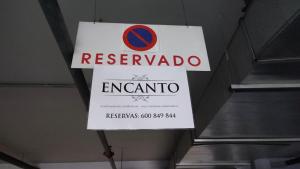 a sign for a restaurant hanging from a ceiling at Apartamentos Turísticos ENCANTO in Cáceres