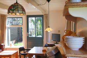 een eetkamer met een tafel en een raam bij Eb in Callantsoog